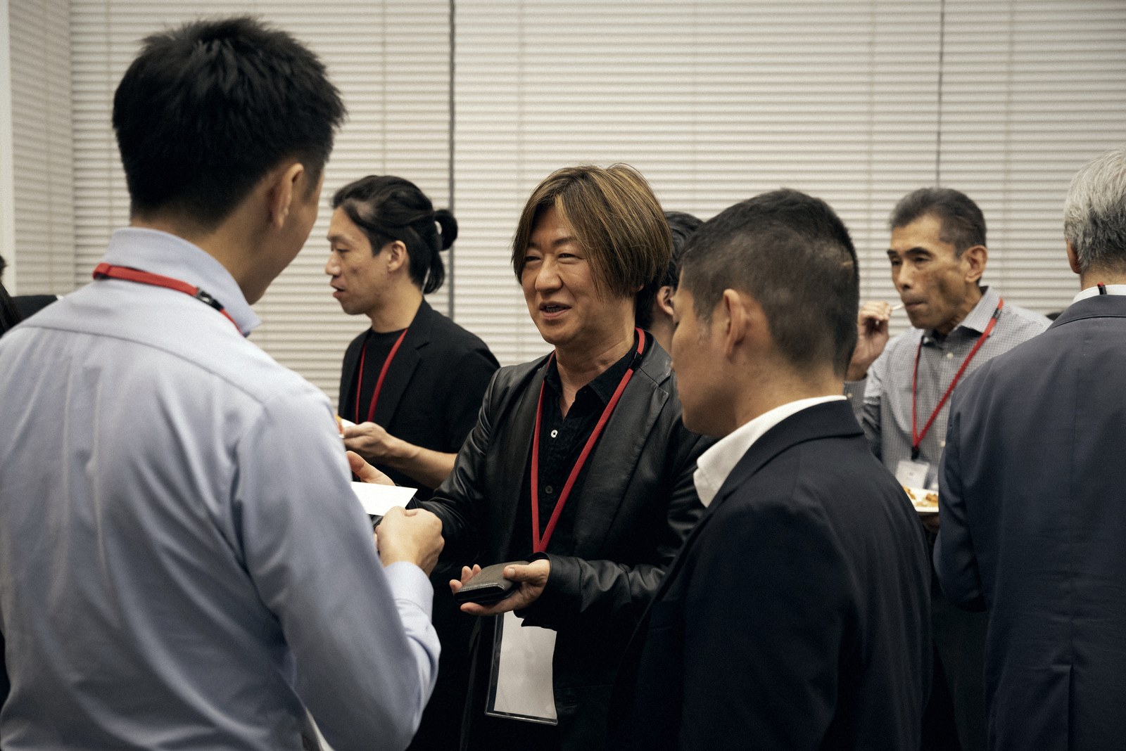Participants exchanging business cards and chatting at the networking reception