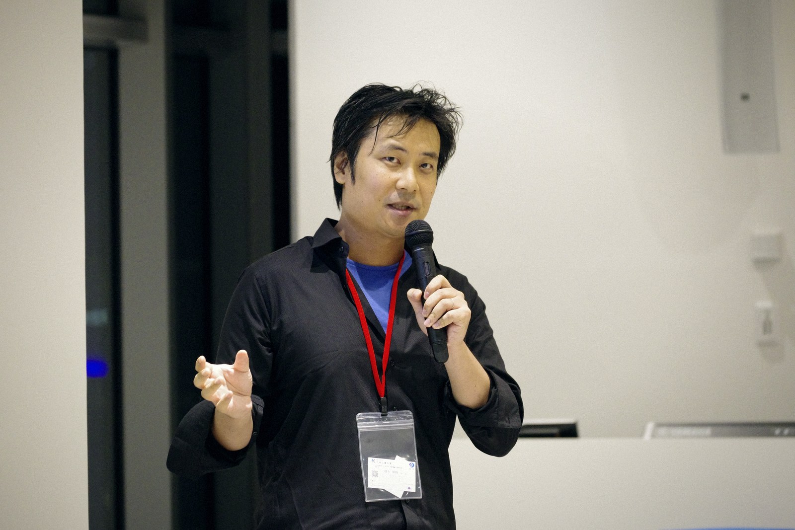 A speaker in a black shirt speaking with intensity